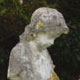 White marble cherub on hexagonal birdbath